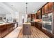 Spacious kitchen with dark cabinets, stainless steel appliances, and a center island at 2430 Tack Hill Ct, Dacula, GA 30019