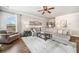 Inviting living room with a large sectional sofa, area rug and a ceiling fan at 2430 Tack Hill Ct, Dacula, GA 30019