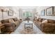 Cozy living room featuring two sofas, a patterned rug, and a bay window at 2430 Tack Hill Ct, Dacula, GA 30019