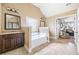 Bright main bathroom featuring a soaking tub, vanity, and tile flooring at 2430 Tack Hill Ct, Dacula, GA 30019