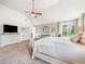 Large main bedroom featuring neutral tones, a ceiling fan, and a sitting area at 2430 Tack Hill Ct, Dacula, GA 30019