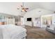 Bright main bedroom with a sitting area, ceiling fan and ensuite bathroom at 2430 Tack Hill Ct, Dacula, GA 30019