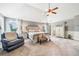 Relaxing main bedroom featuring a tray ceiling, ceiling fan, and bedside tables at 2430 Tack Hill Ct, Dacula, GA 30019