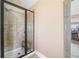 Tiled shower with glass door, bench, and chrome fixtures in the main bathroom at 2430 Tack Hill Ct, Dacula, GA 30019