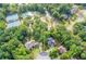 Aerial view of a beautiful home nestled among lush trees with a manicured lawn at 4910 Aldbury Ln, Suwanee, GA 30024