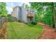 Well-maintained backyard with lush lawn, mature trees, and a wooden fence at 4910 Aldbury Ln, Suwanee, GA 30024