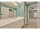 Bright bathroom featuring a large vanity, decorative mirror, and access to bedroom and the shower/toilet area at 4910 Aldbury Ln, Suwanee, GA 30024