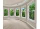 View of bedroom with a lot of natural light, and view of trees and nature outside the window at 4910 Aldbury Ln, Suwanee, GA 30024
