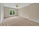 Spacious bedroom featuring neutral walls, ceiling fan, plush carpet, and great light at 4910 Aldbury Ln, Suwanee, GA 30024