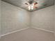 Neutral bedroom with carpet flooring, decorative brick walls and a ceiling fan at 4910 Aldbury Ln, Suwanee, GA 30024