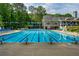 The sparkling community pool features a lap lane and ample lounge chairs for relaxing under the sun at 4910 Aldbury Ln, Suwanee, GA 30024