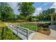 A charming pool area with lush landscaping, tennis courts, and covered picnic area offers a relaxing community space at 4910 Aldbury Ln, Suwanee, GA 30024