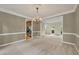 Elegant dining room featuring a chandelier and view of the kitchen at 4910 Aldbury Ln, Suwanee, GA 30024