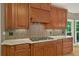 Close up of a kitchen with wooden cabinets, granite countertops, and stainless steel appliances at 4910 Aldbury Ln, Suwanee, GA 30024