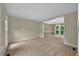 Expansive living room featuring plush carpet and view into the dining room at 4910 Aldbury Ln, Suwanee, GA 30024