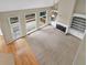 Living room featuring a fireplace, high ceilings, fan, hardwood floors, and sliding door access to back deck at 4910 Aldbury Ln, Suwanee, GA 30024