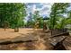 A fun community playground surrounded by mature trees provides children with a safe space to play and explore at 4910 Aldbury Ln, Suwanee, GA 30024