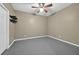 Room with hard surface floors, ceiling fan and a door at 4910 Aldbury Ln, Suwanee, GA 30024