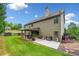 Exterior of home showcasing a large backyard and patio with outdoor seating and a grill at 501 Rabun Ct, Canton, GA 30115