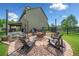 Backyard with stone fire pit, chairs, and string lights for outdoor entertaining at 501 Rabun Ct, Canton, GA 30115