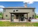 Exterior view of home featuring a backyard with a covered patio and grill area at 501 Rabun Ct, Canton, GA 30115