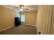 Cozy bedroom features neutral walls, plush carpet, ceiling fan, and a large window for natural light at 501 Rabun Ct, Canton, GA 30115