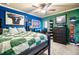Spacious bedroom decorated with sports memorabilia, with blue and green walls at 501 Rabun Ct, Canton, GA 30115