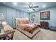 Cozy bedroom features a unique upholstered headboard, and light blue walls at 501 Rabun Ct, Canton, GA 30115