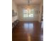 Bright dining room boasts hardwood floors, shiplap walls, and a view of the outdoors at 501 Rabun Ct, Canton, GA 30115