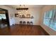 Bright dining room boasts shiplap walls, rich hardwood floors, and modern industrial lighting fixture at 501 Rabun Ct, Canton, GA 30115