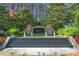 Community entrance featuring a stone sign, water fountain, and landscaped surroundings at 501 Rabun Ct, Canton, GA 30115