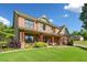 Stunning two-story home with a brick and stone facade, featuring a covered front porch at 501 Rabun Ct, Canton, GA 30115