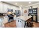 Well-equipped kitchen with an island, stainless steel appliances and wooden stools at 501 Rabun Ct, Canton, GA 30115