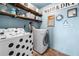 Laundry room with polka dot washing machine and shelves with storage bins at 501 Rabun Ct, Canton, GA 30115