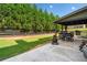 View of the patio and backyard featuring a fire pit and outdoor seating under a covered area at 501 Rabun Ct, Canton, GA 30115