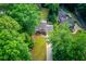 Aerial view of a home with a well-maintained lawn and tree-lined surroundings at 6006 Lanier Heights Cir, Buford, GA 30518
