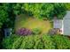 An aerial view of the property showcasing a spacious backyard surrounded by trees, providing privacy and natural beauty at 6006 Lanier Heights Cir, Buford, GA 30518