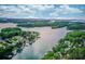 Breathtaking aerial view of waterfront homes surrounded by lush green trees and the serene waters of Lake Hartwell at 6006 Lanier Heights Cir, Buford, GA 30518