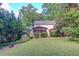 Beautifully landscaped backyard with a screened-in porch, perfect for relaxing and entertaining guests at 6006 Lanier Heights Cir, Buford, GA 30518