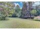 Beautiful backyard with lush green grass and mature trees at 6006 Lanier Heights Cir, Buford, GA 30518