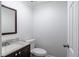 Cozy half bathroom with dark wood vanity and chrome faucet at 6006 Lanier Heights Cir, Buford, GA 30518