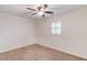 Cozy carpeted bedroom with natural lighting, white walls and trim, and a ceiling fan at 6006 Lanier Heights Cir, Buford, GA 30518