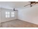 Spacious bedroom with carpet, dual windows, and ceiling fan at 6006 Lanier Heights Cir, Buford, GA 30518