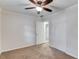 Carpeted bedroom with ceiling fan, double closet, and an open door to the hallway at 6006 Lanier Heights Cir, Buford, GA 30518