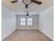 Carpeted bedroom featuring a ceiling fan and large windows at 6006 Lanier Heights Cir, Buford, GA 30518