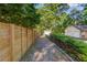 A long driveway leading to a garage, with a wooden fence lining one side for added privacy at 6006 Lanier Heights Cir, Buford, GA 30518