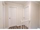 Upstairs hallway with two doors leading to bedrooms at 6006 Lanier Heights Cir, Buford, GA 30518