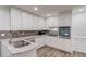 Bright kitchen featuring white cabinets, stone countertops and stainless steel appliances at 6006 Lanier Heights Cir, Buford, GA 30518
