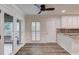 Breakfast area featuring white cabinets, stone countertops and access to the deck at 6006 Lanier Heights Cir, Buford, GA 30518
