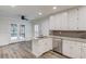 Open kitchen featuring white cabinets, granite countertops and stainless steel appliances at 6006 Lanier Heights Cir, Buford, GA 30518